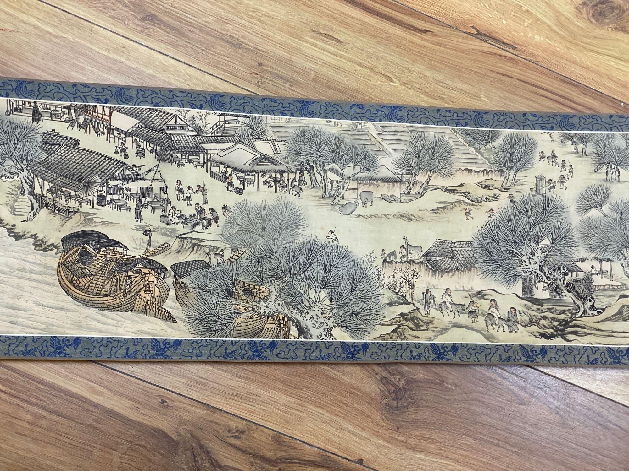 A Chinese landscape painting on silk handscroll with script, approximately 520 x 22cm